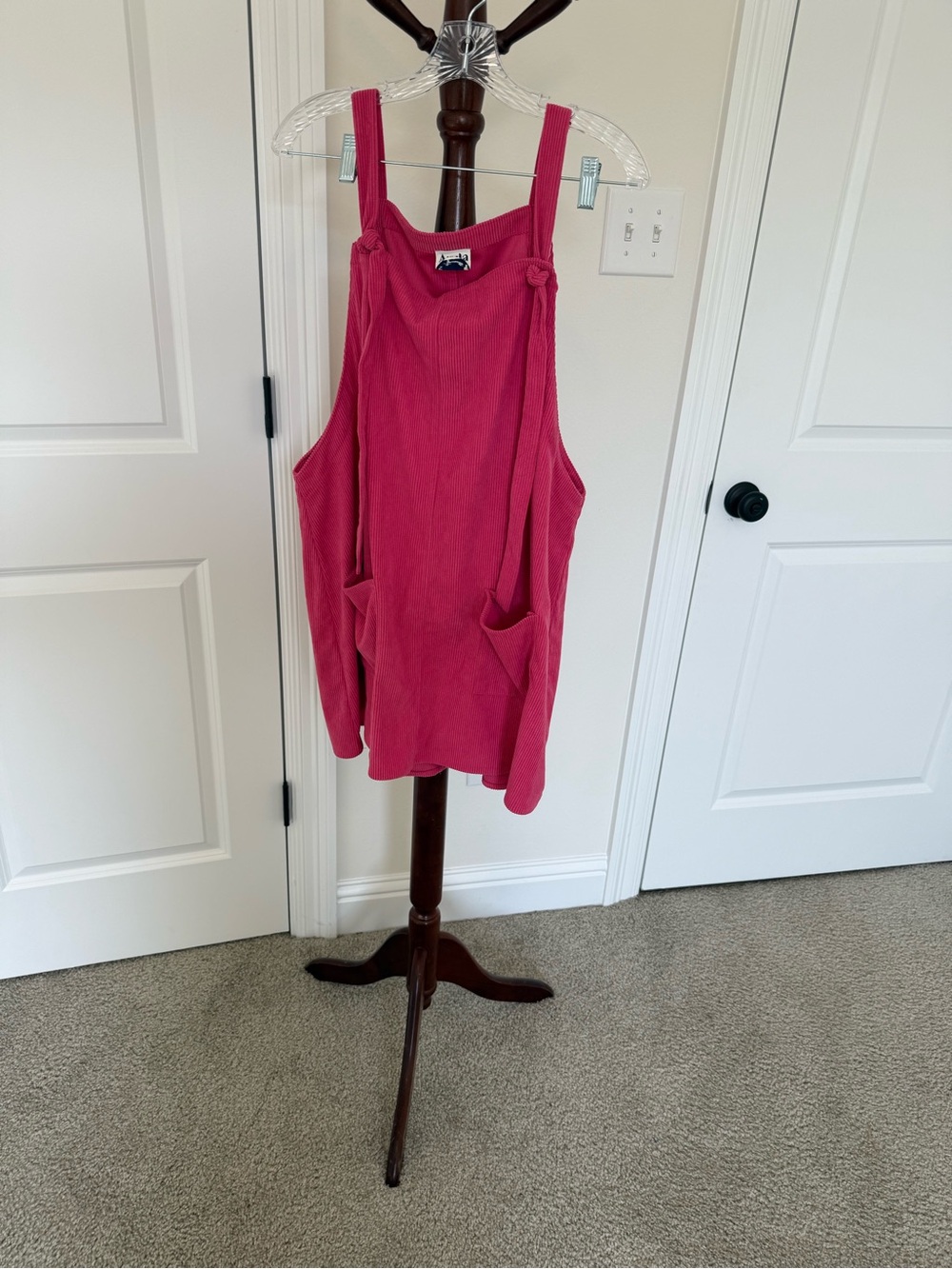 Pink tie strap dress with front pockets.